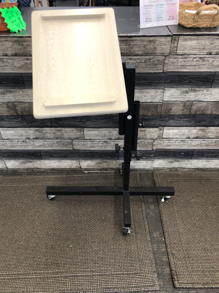BLACK METAL BASE STANDING ADJUSTABLE DESK FAUX WHITE WOOD TOP ON WHEELS.