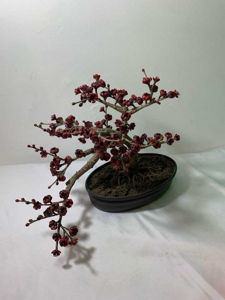 FAUX BONSAI TREE W/ RED FLOWERS IN OVAL PLANTER.