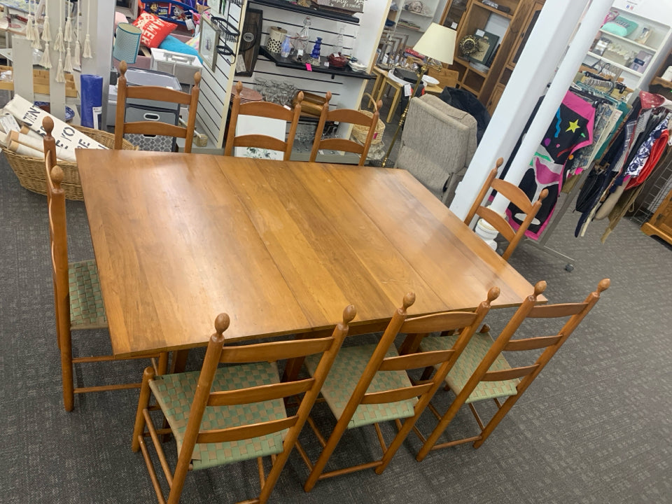 WOOD DINING TABLE W/8 LADDER BACK WOVEN SEAT CHAIRS AND LEAF.