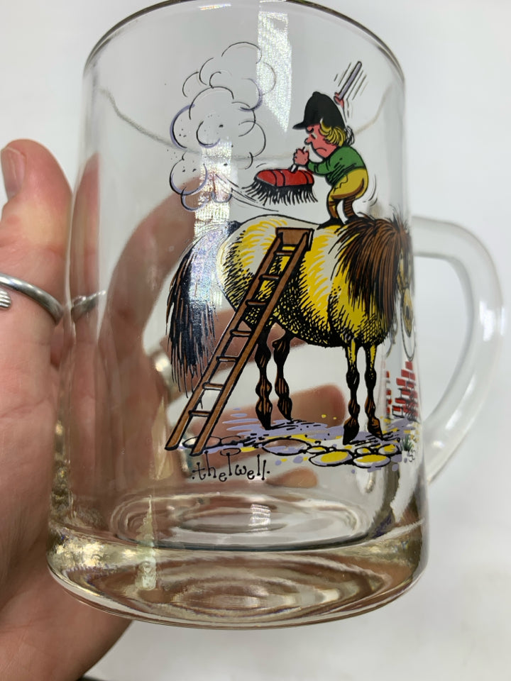 CLEAR GLASS MUG W/ PRINTED MAN ON HORSE BRUSHING IT OFF.