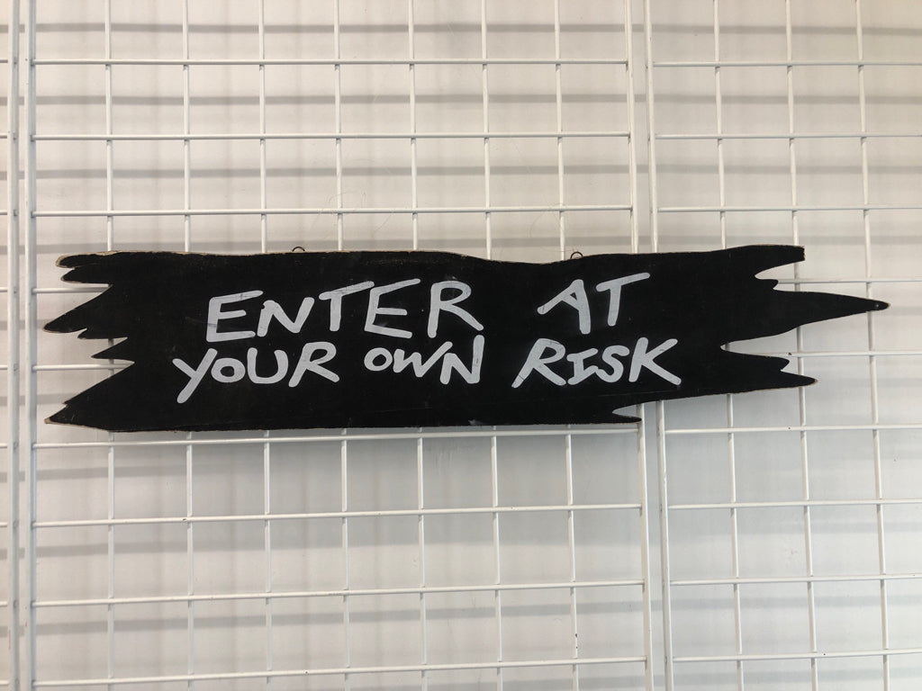 ENTER AT YOUR OWN RISK WOOD SIGN.