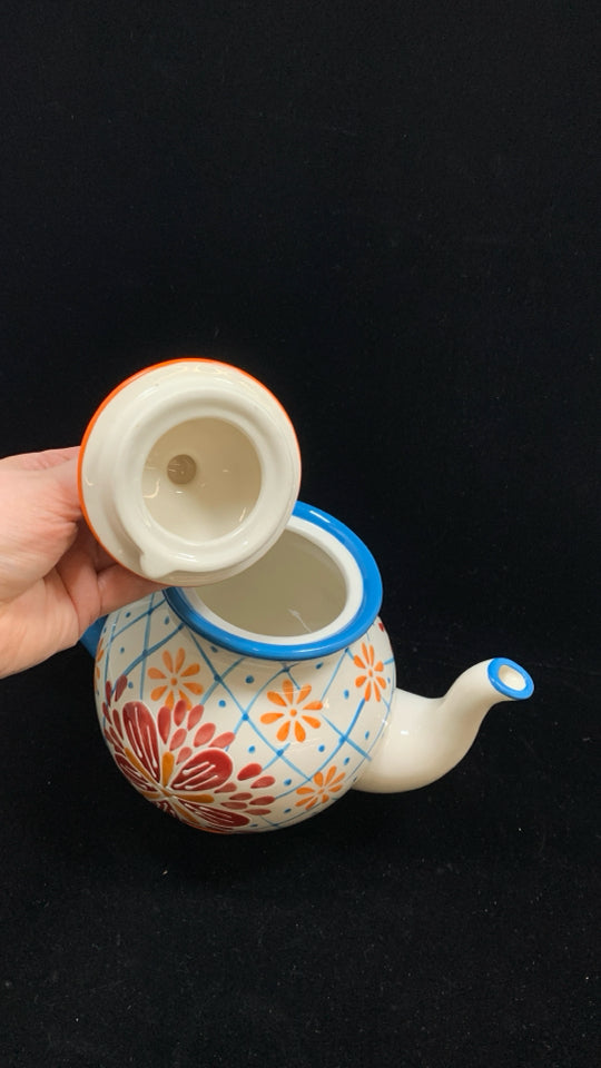 COLORFUL FLORAL TEAPOT W/BLUE HANDLE.