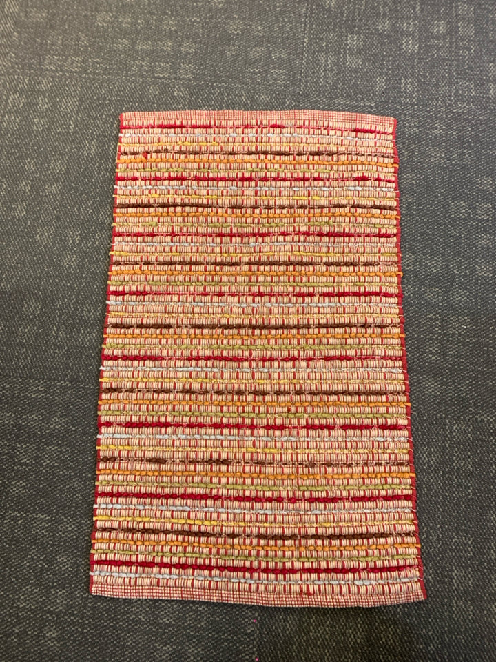 SMALL RED AND YELLOW PATTERN AREA RUG.