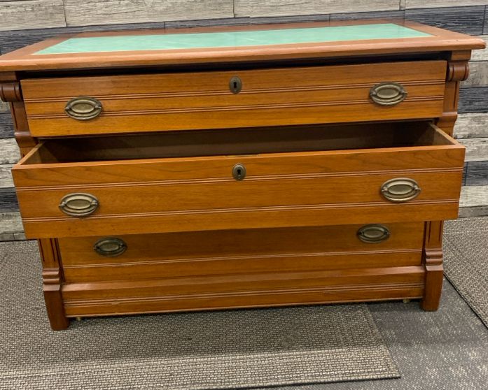 CHERRY WOOD CABINET W 3 DRAWERS AND GREEN MARBLE TOP.