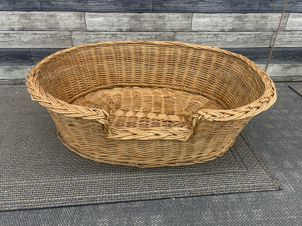 LARGE WICKER OVAL DOG BED.