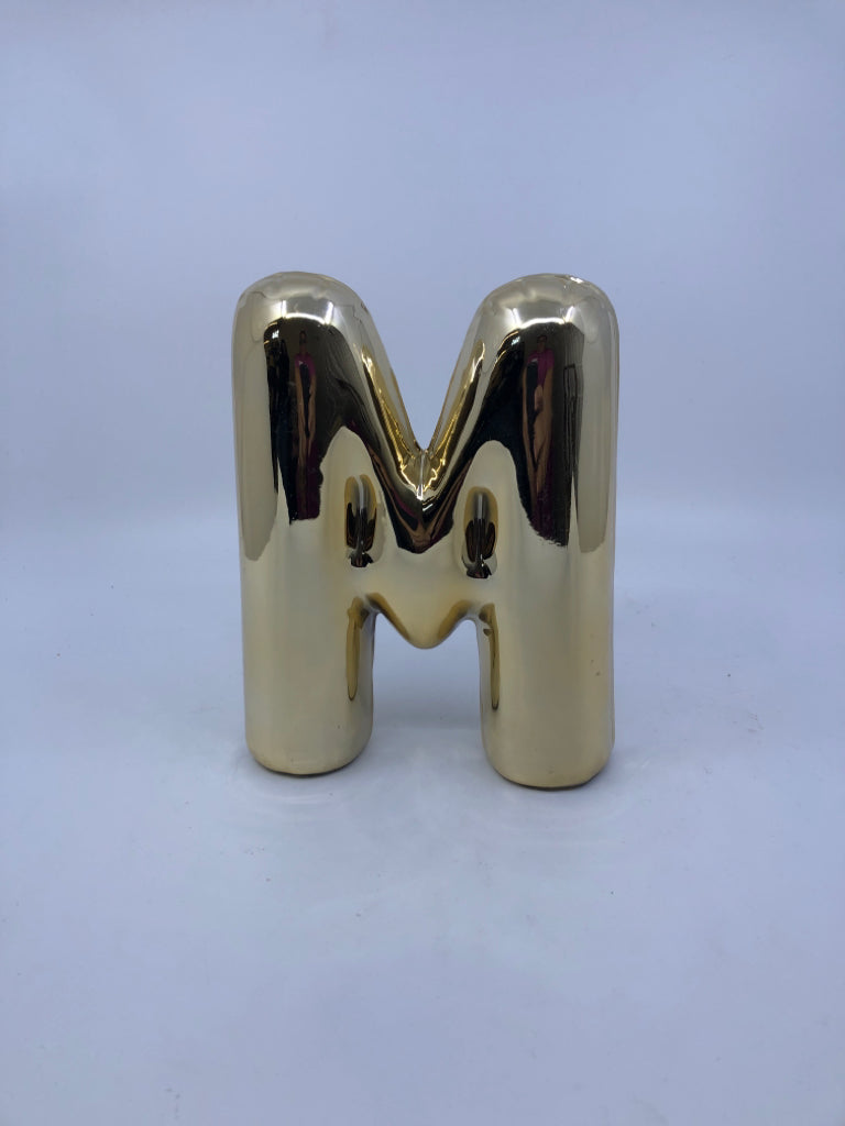 GOLD "M".