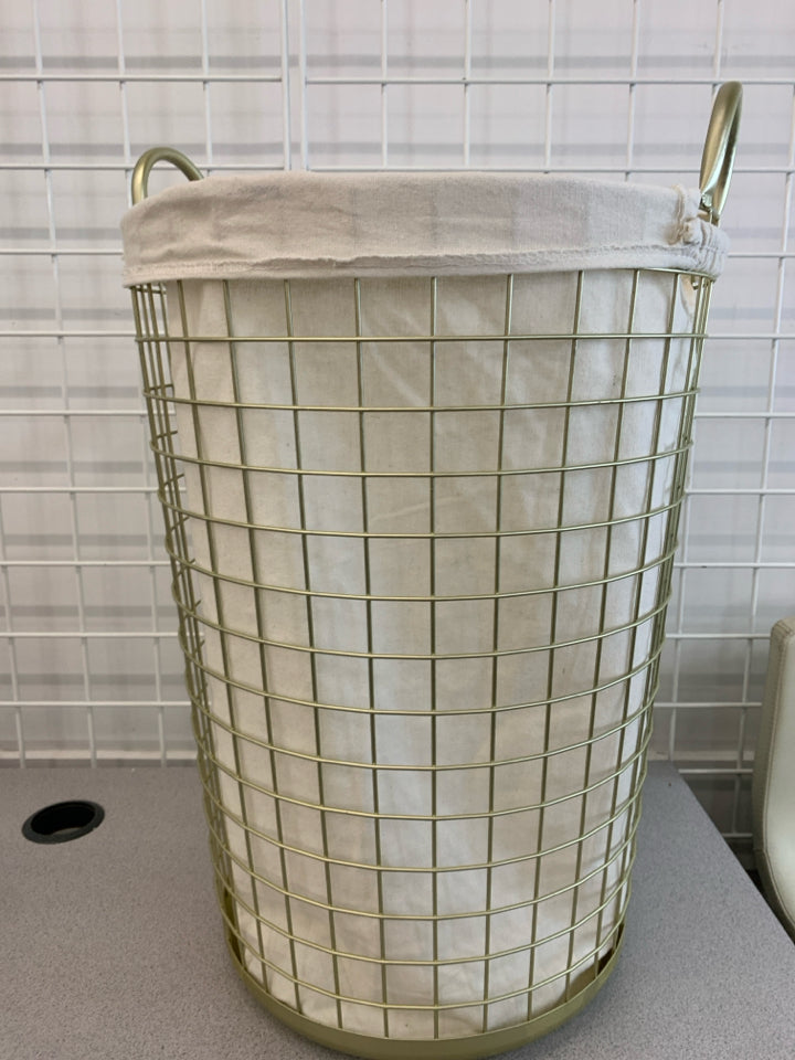GOLD HAMPER W/ WHITE FABRIC LINER.