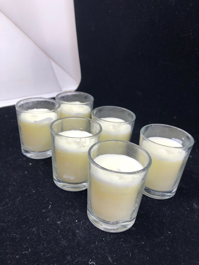 6 SCENTED VOTIVE CANDLES.