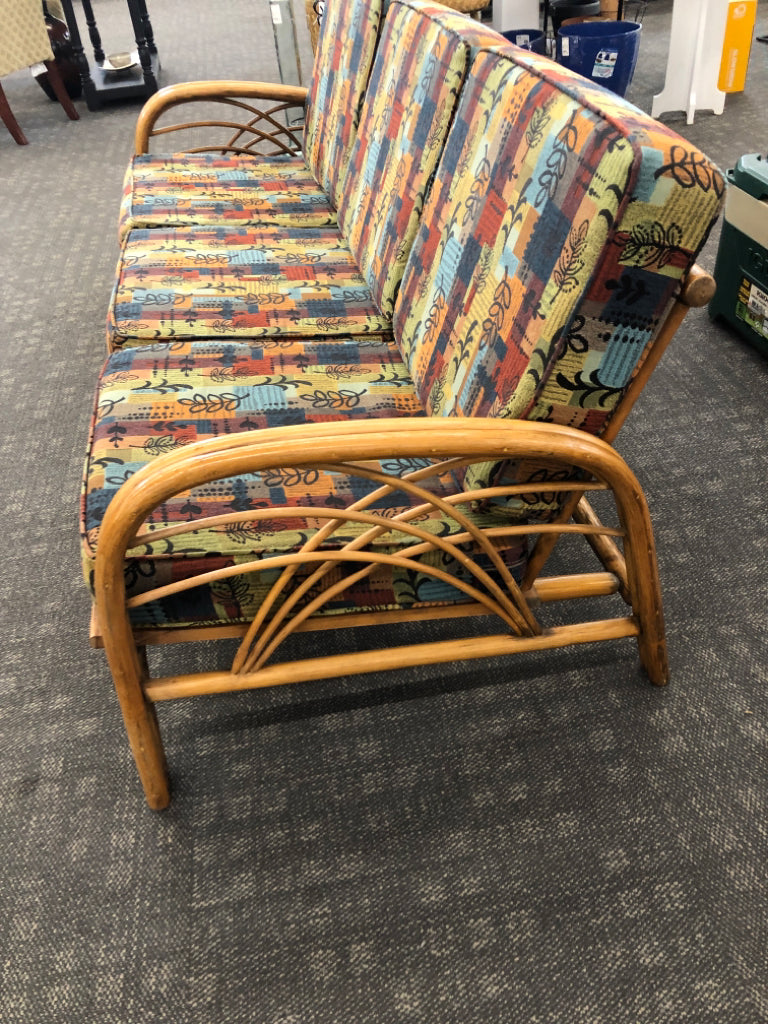 RATTAN SOFA W/PATTERNED FABRIC.
