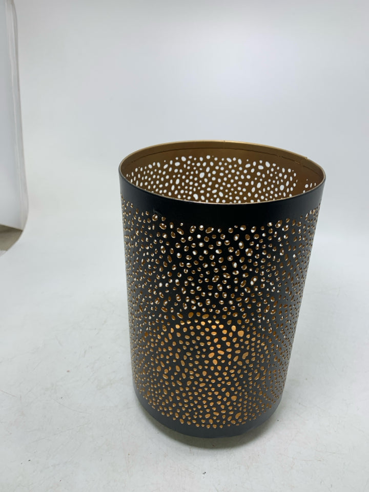 FOOTED METAL PIERCED PILLAR CANDLE HOLDER.