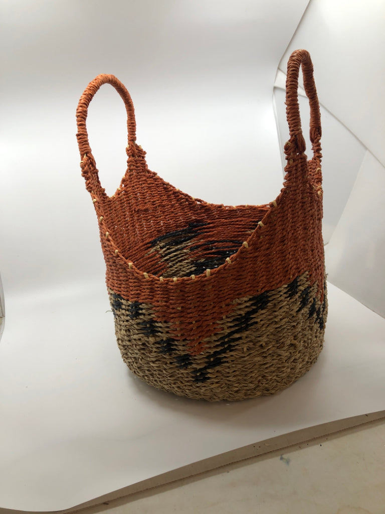 ORANGE AND TAN WICKER BASKET WITH BLUE ACCENTS.
