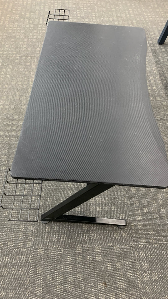 BLACK PLASTIC GAMING DESK W/ANGLED METAL LEGS.
