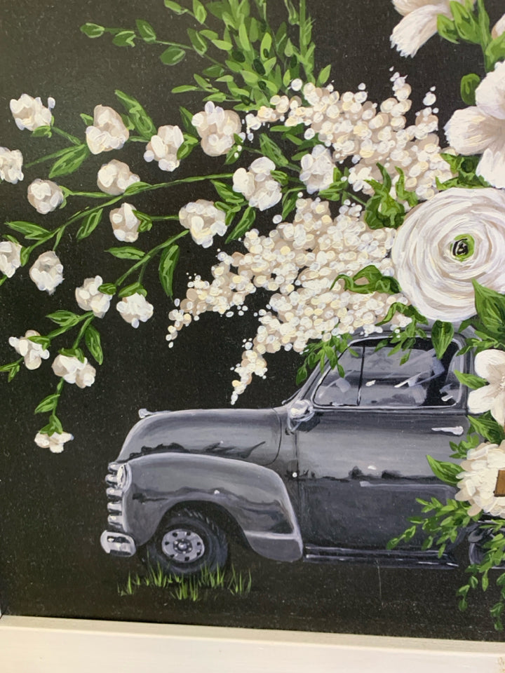 BLACK TRUCK W WHITE FLORAL IN WHITE FRAME WALL DECOR.