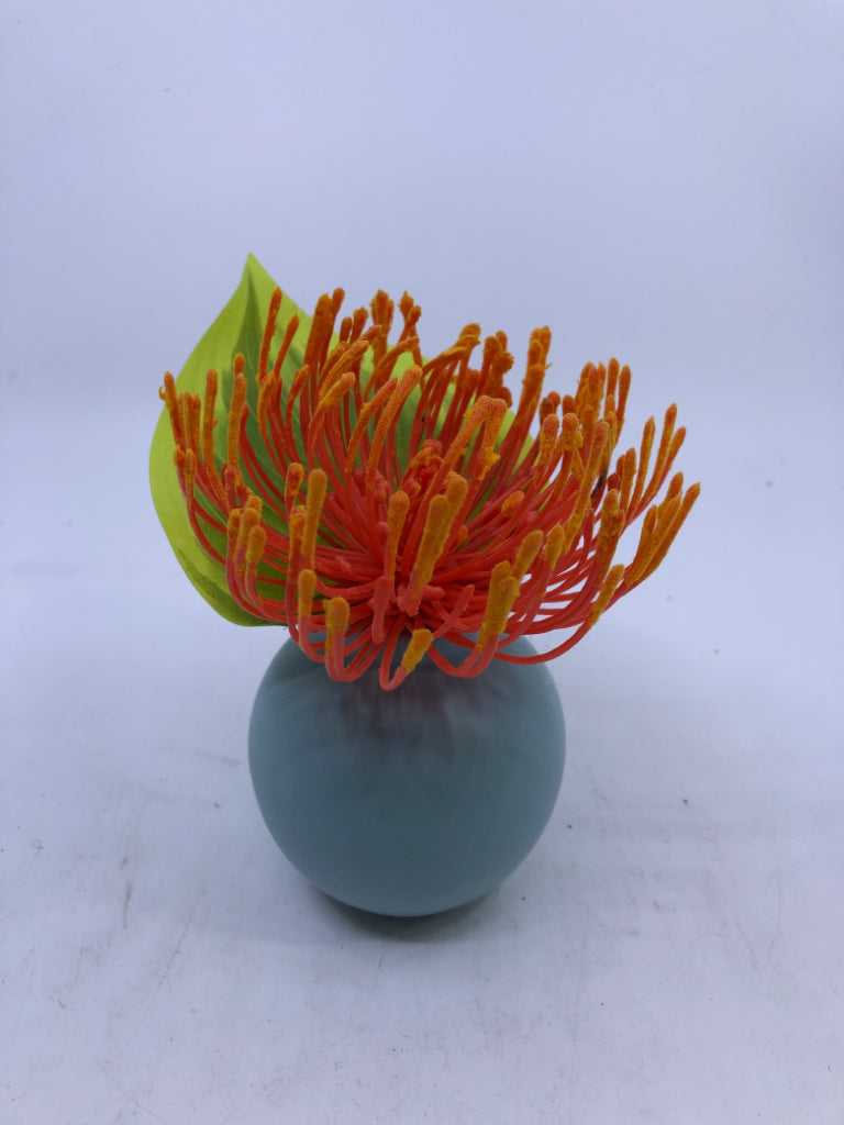 SMALL TEAL VASE W/ FAUX LEAVE ORANGE FLOWER.