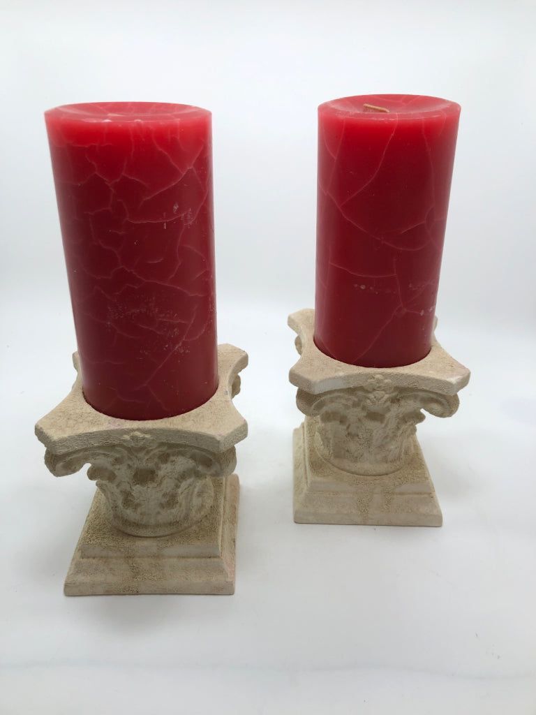 2 ROMAN COLUMN CERAMIC CANDLE HOLDERS W/RED CANDLES.