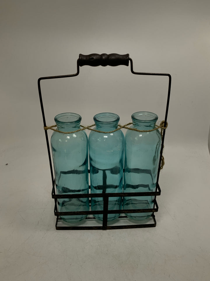 3 BLUE BOTTLES IN METAL CARRIER.