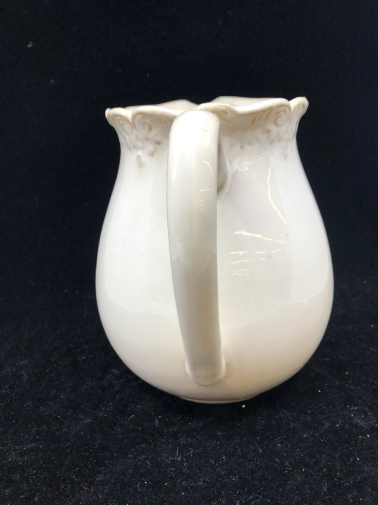 CREAM W SLIGHT EMBOSSED RIM PITCHER.
