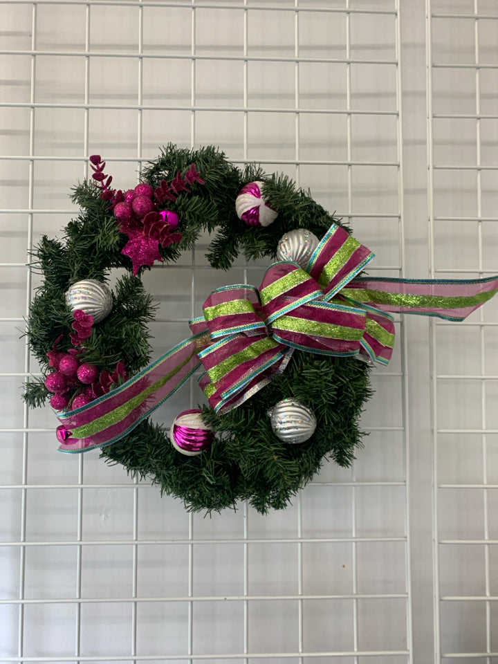 LARGE WREATH W ORNAMENTS AND PINK AND GREEN BOW.