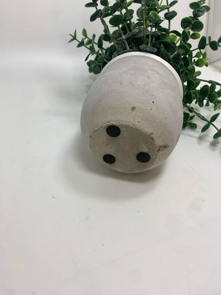 FAUX GREENS IN CEMENT POT.