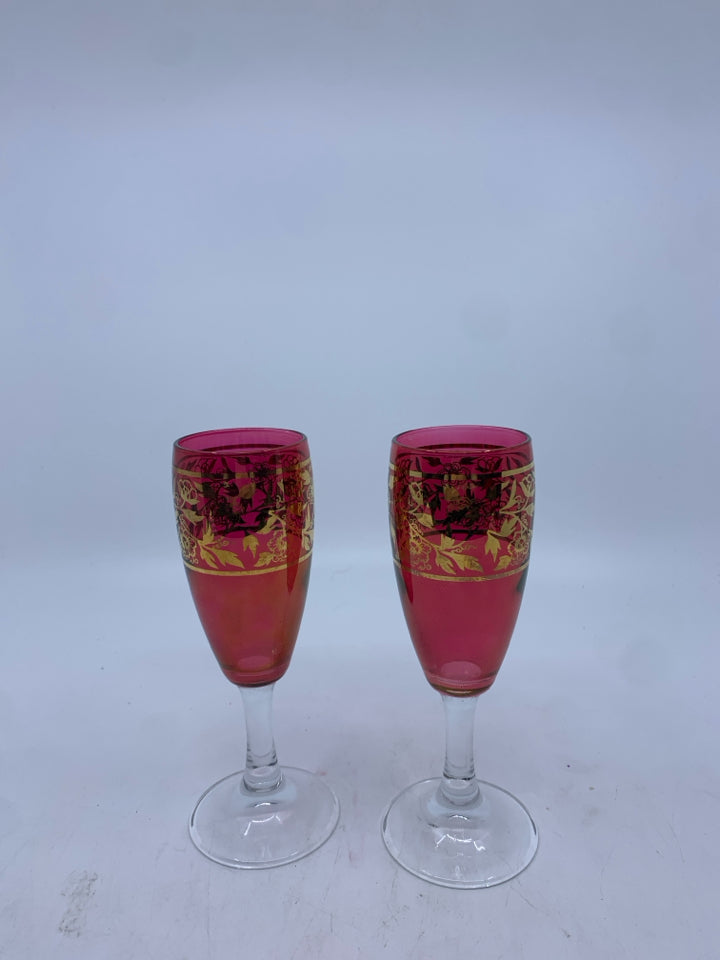 2 RED CHAMPAGNE FLUTES W/ GOLDEN FLOWER DESIGN MADE IN ITALY.