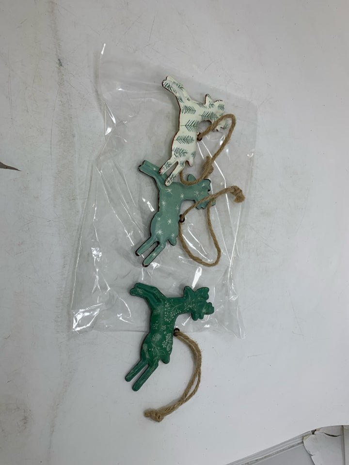 3 METAL PRINTED REINDEER ORNAMENTS IN BAG.