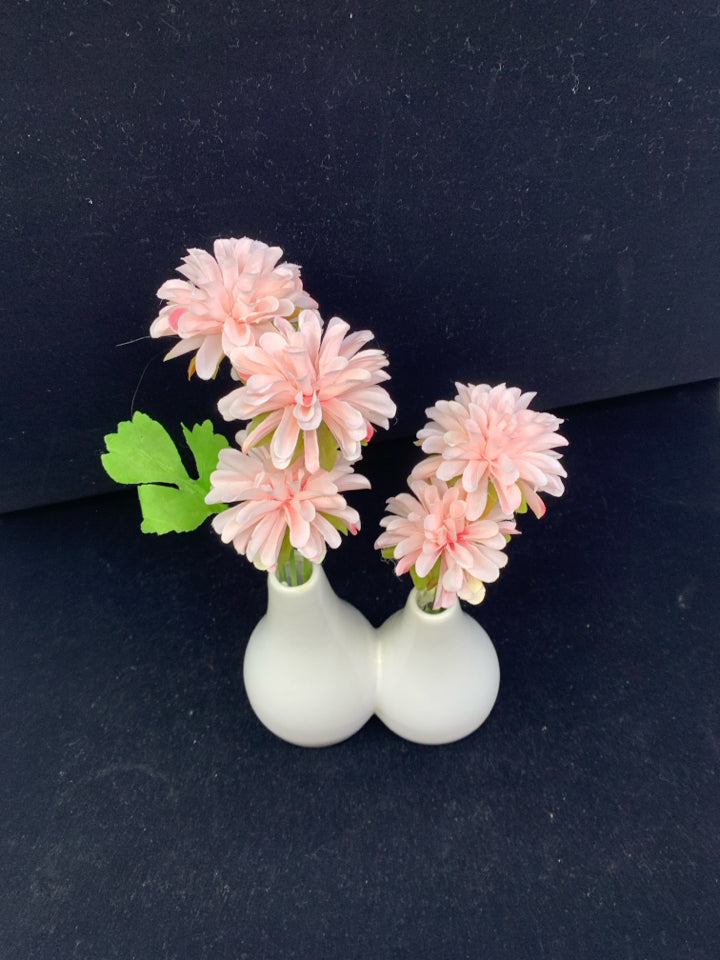 FAUX PINK FLORAL IN WHITE CONNECTED VASES.