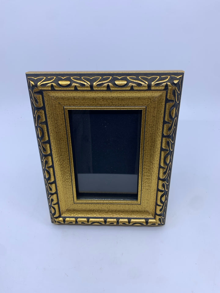 GOLD PHOTO FRAME W/ BLACK DESIGNS.