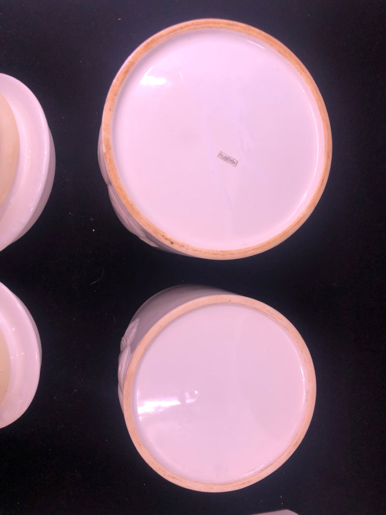 2 WHITE EMBOSSED APPLE CANISTERS.