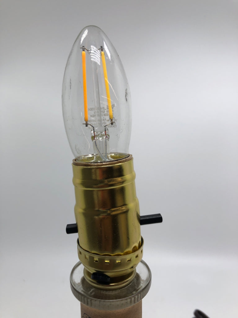 BOURBON BOTTLE LAMP W/TAN SHADE.