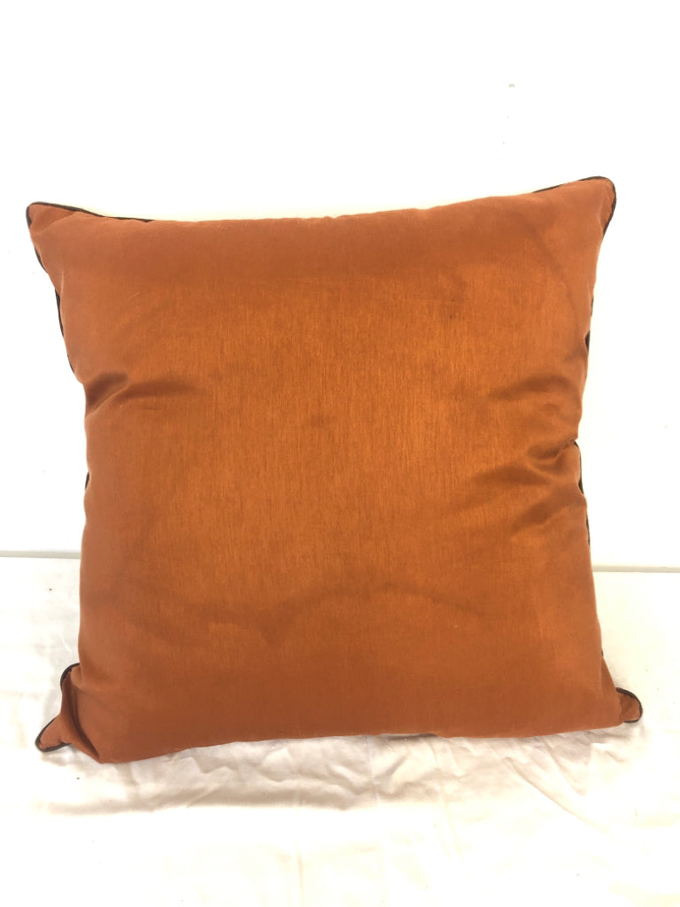 BURNT ORANGE PILLOW W/ STITCHED PATTERN.