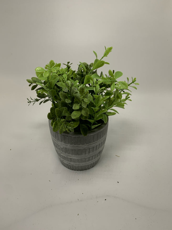 GREY W/ WHITE LINES PLANTER W/ FAUX LEAVES.