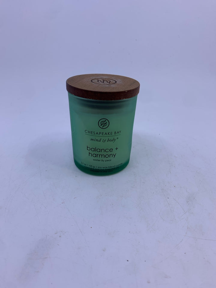 NEW BALANCE & HARMONY SCENTED CANDLE IN GREEN JAR.