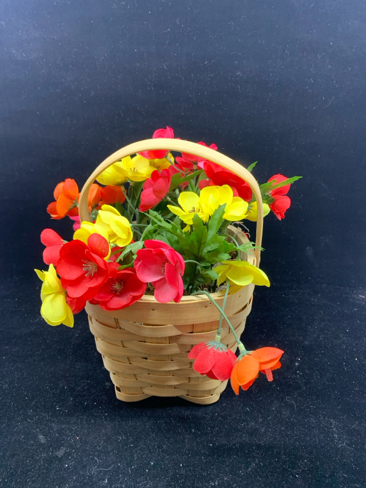 FAUX YELLOW AND PINK FLOWERS IN BASKET.