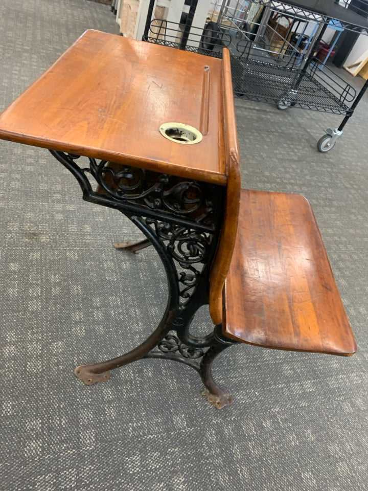 VTG DK WOOD SCHOOL DESK W/IRON SCROLL BASE.