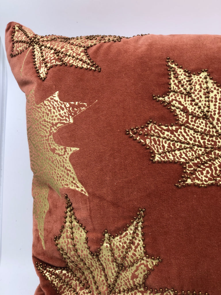 RUST COLORED PILLOW W/ BEADED GOLD MAPLE LEAVES.