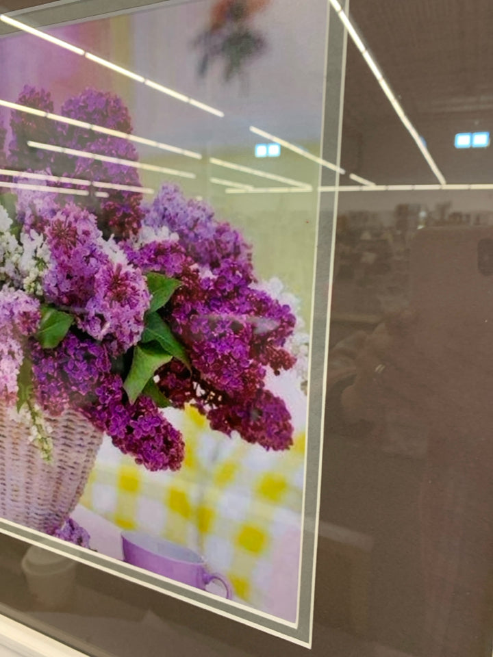 LILACS IN WHITE BASKET IN WHITE FRAME.