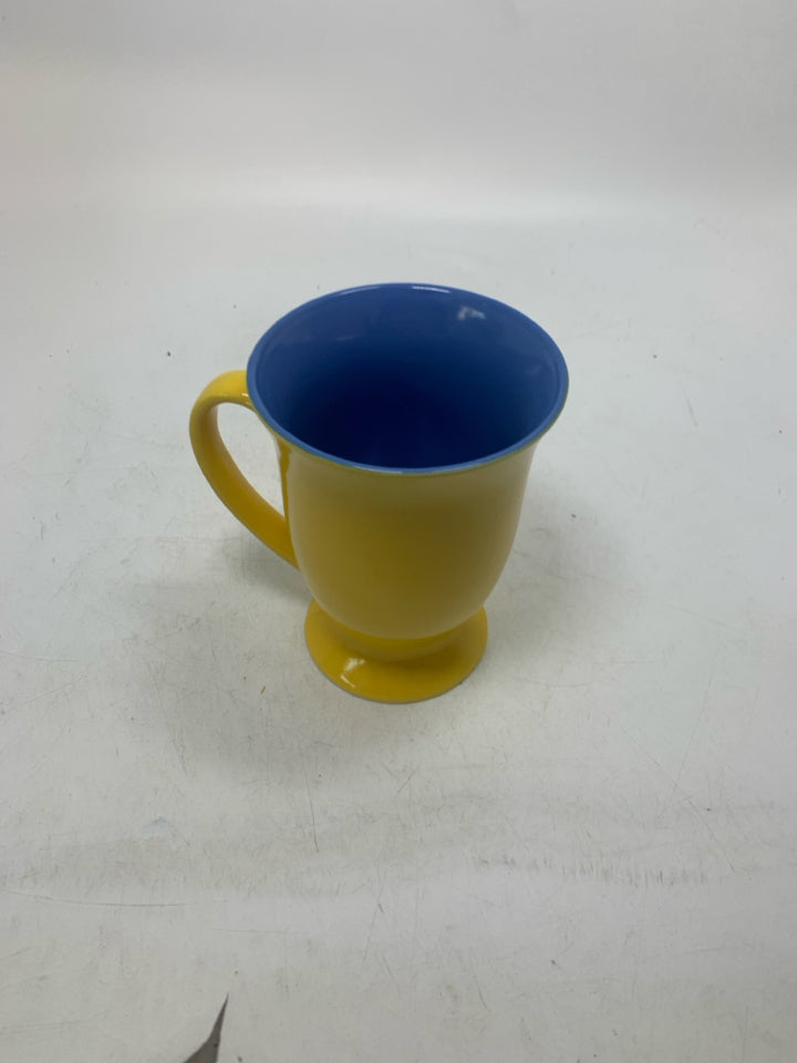 FOOTED SMILEY FACE MUG W/ BLUE INSIDE.