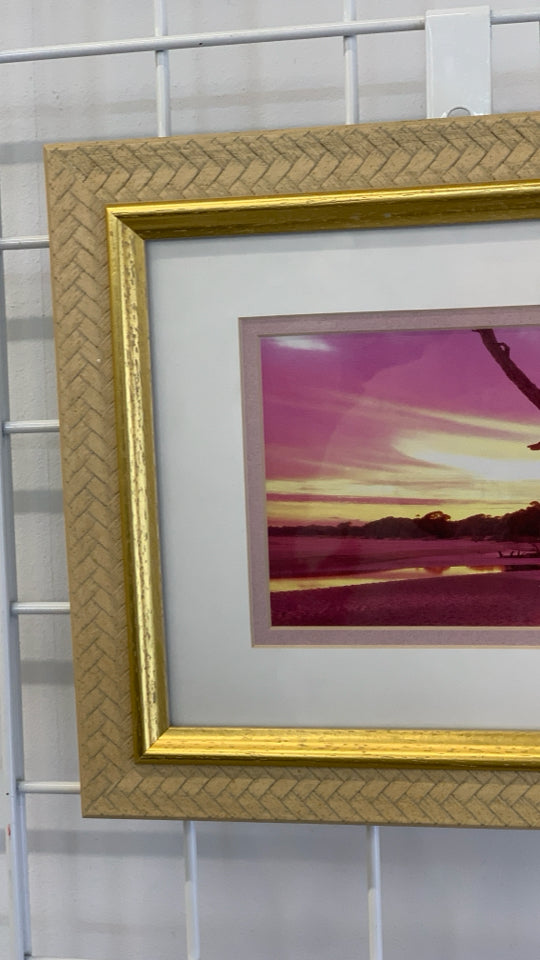 SUNSET PHOTO IN GOLD FRAME.
