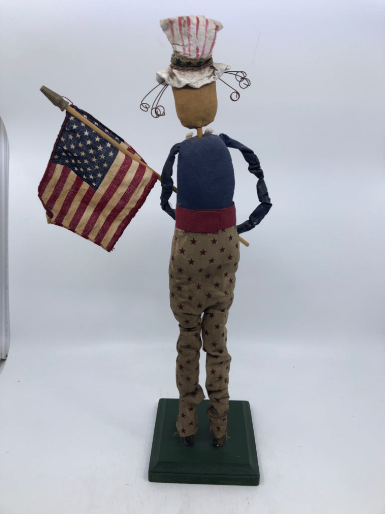 PRIMITIVE MAN HOLDING FLAG.