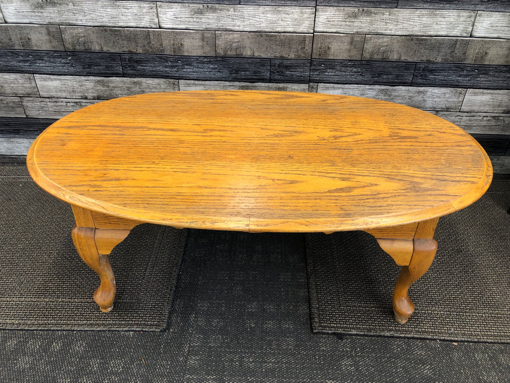 OAK WOOD OVAL COFFEE TABLE .