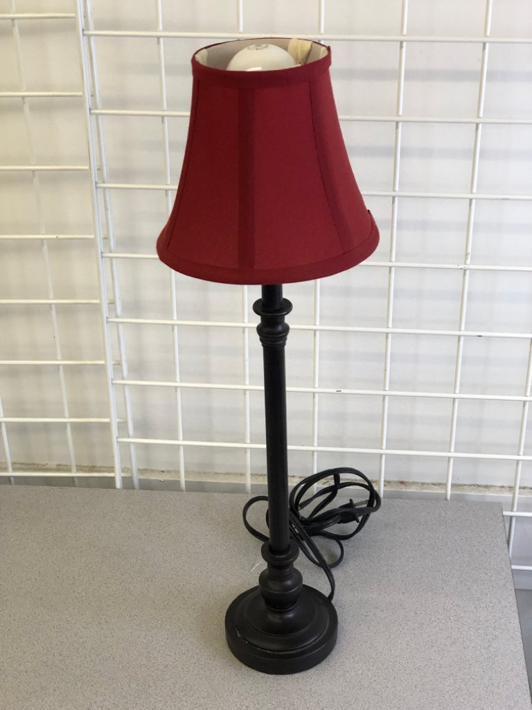 SKINNY BLACK BASE LAMP W/ RED SHADE.