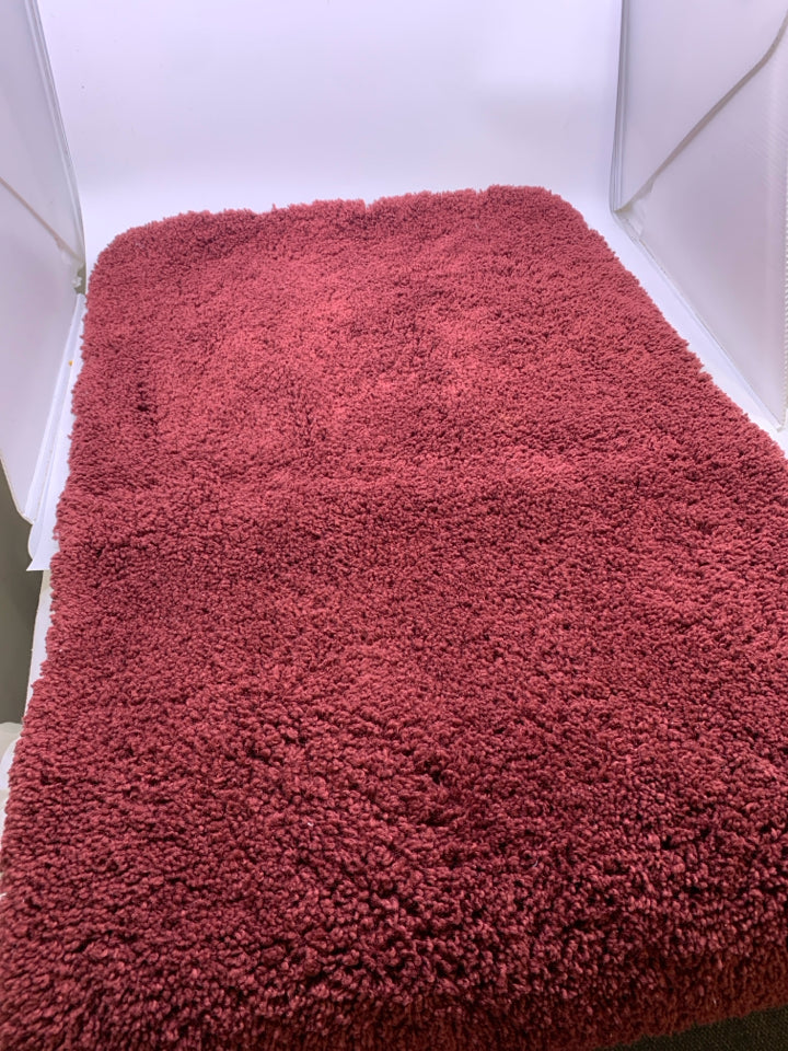 RED BATH MAT.