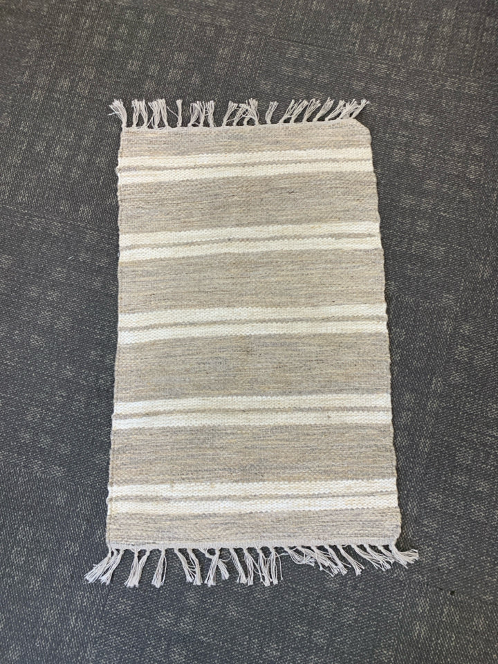 CREAM STRIPE AREA RUG W FRINGE.