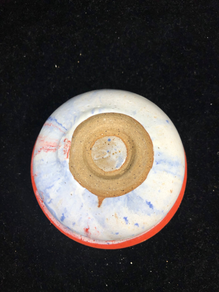 ORANGE POTTERY BOWL W LIGHT OUTSIDE.