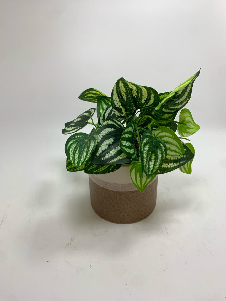 FAUX PLANT IN TAN CERAMIC POT.
