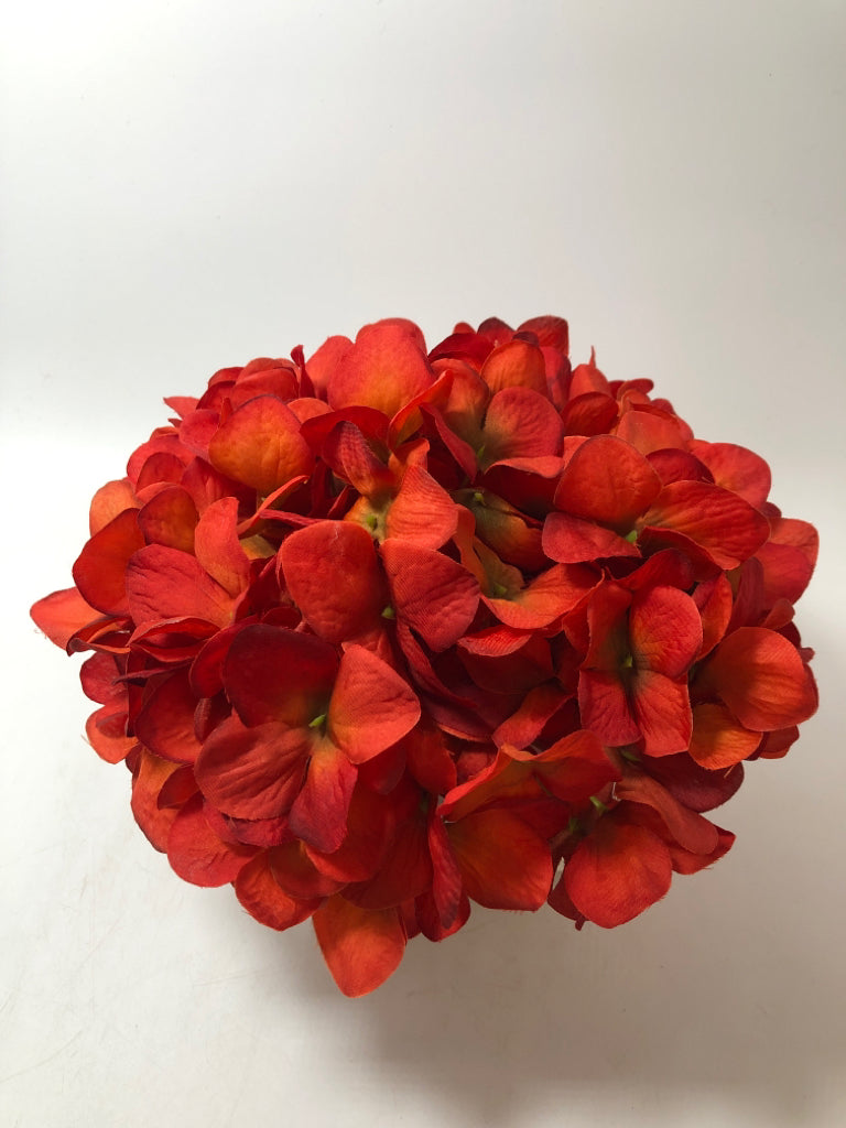 RED FLORALS IN "X" FRAME PLANTER.