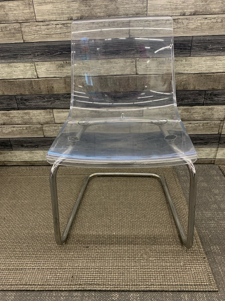 CLEAR IKEA CHAIR W/ METAL BOTTOM.