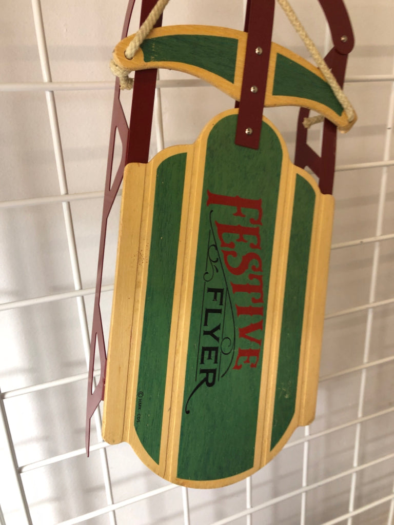 FESTIVE WOOD AND METAL SLED DECOR.