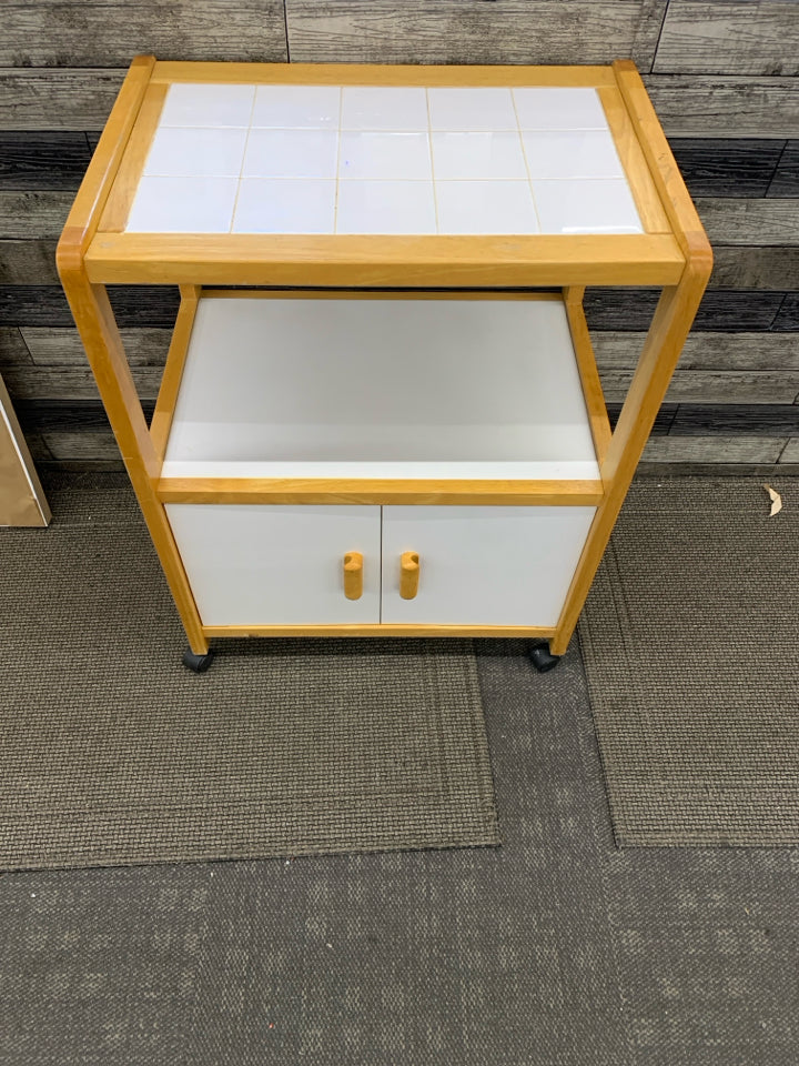 ROLLING KITCHEN CART BLONDE WOOD & WHITE W/TILE COUNTER TOP & 2 DOORS.