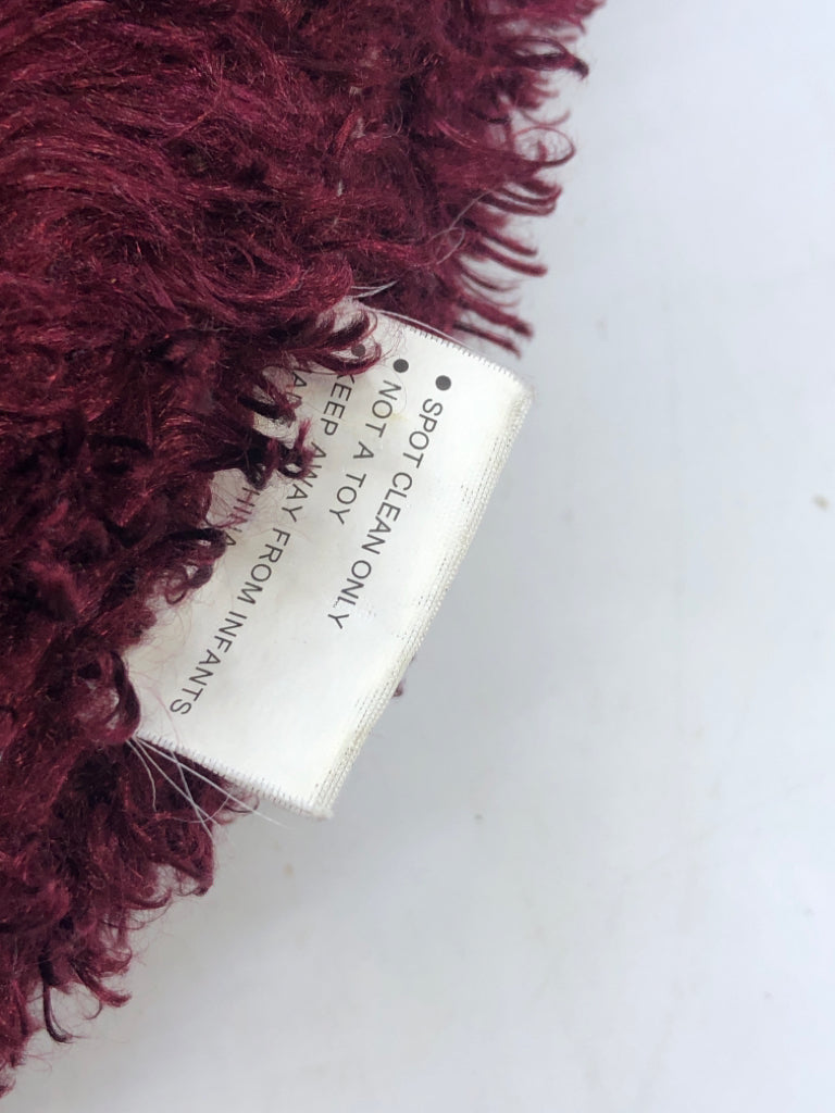 ROUND MAROON PILLOW.